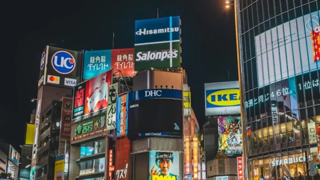 Bright billboards and illuminated buildings in Shibuya district Tokyo Japan at night