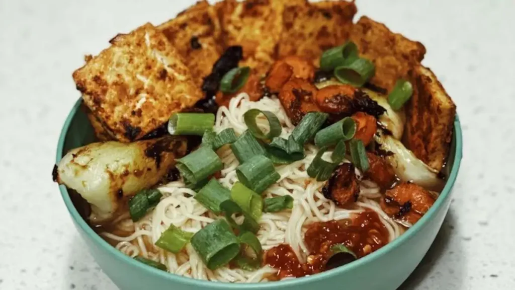Vegan ramen bowl with noodles tofu vegetables and green onions served in Tokyo Japan